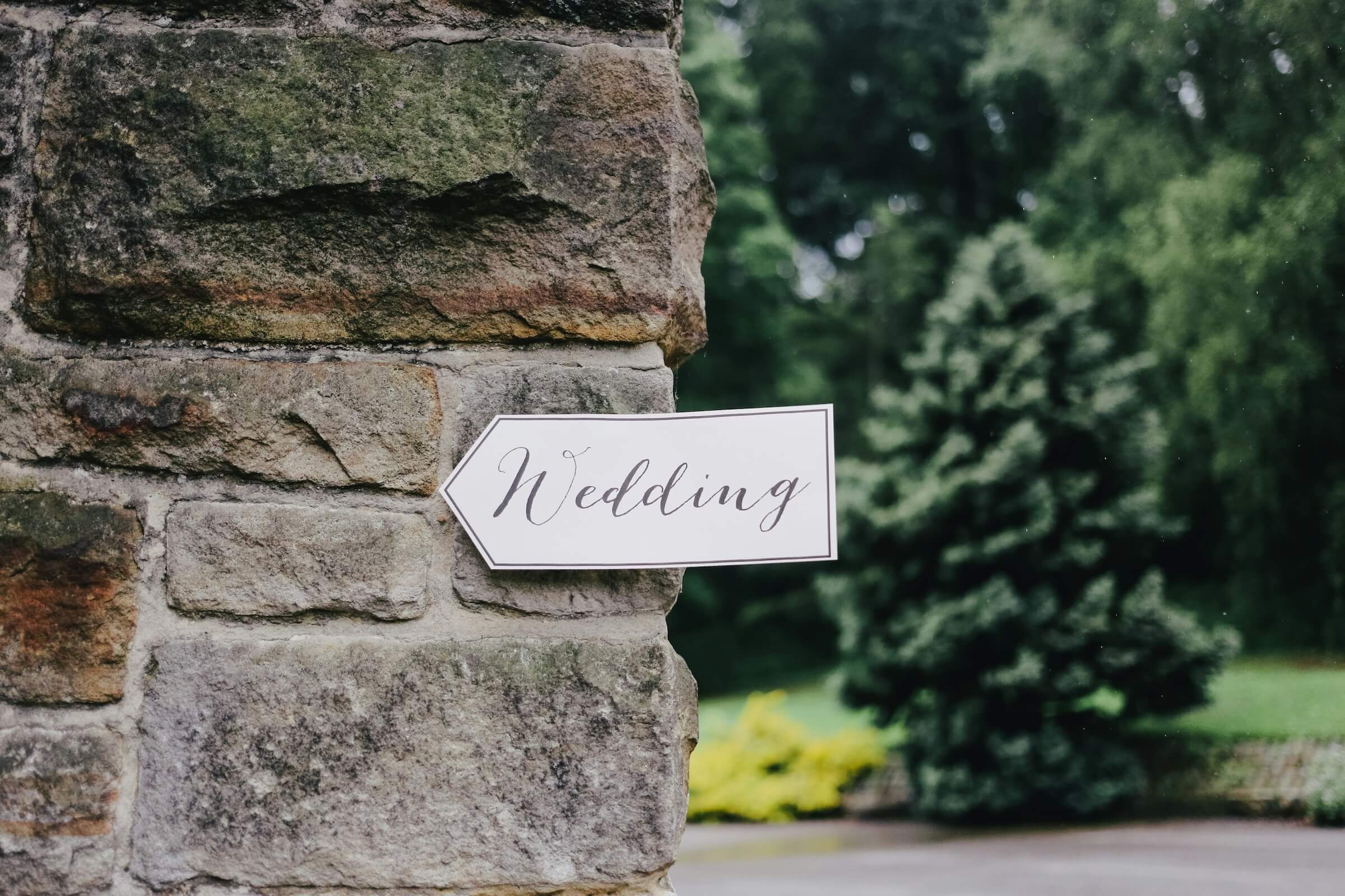 wedding sign at stone wall