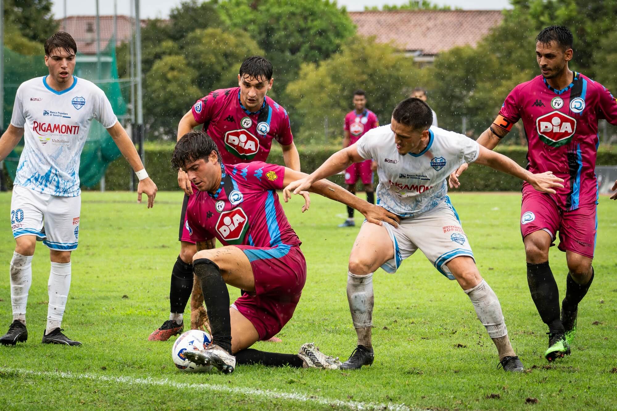 Intense football match on a rainy day